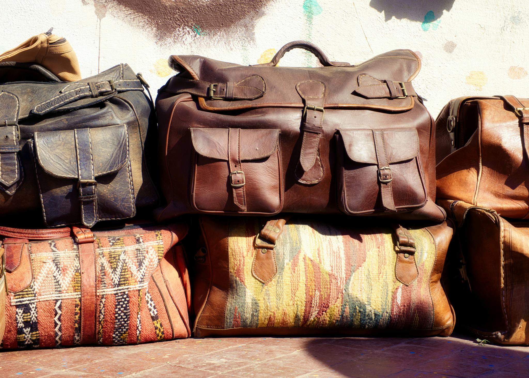 A vibrant display of leather and textile bags in Fes, Morocco, showcasing authentic Moroccan craftsmanship.
